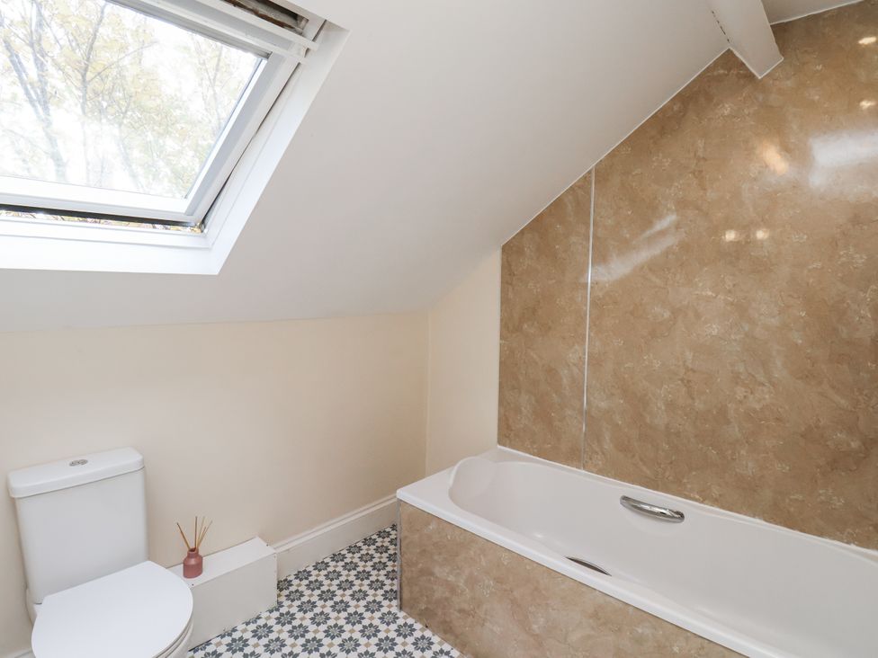 A bathroom with a bathtub and toilet at 2 High Stakesby Cottages in Whitby