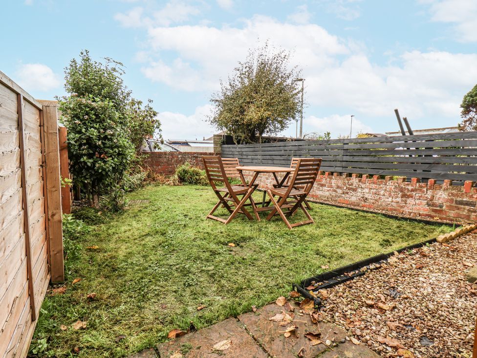 A garden with a table and chairs at 2 High Stakesby Cottages in Whitby