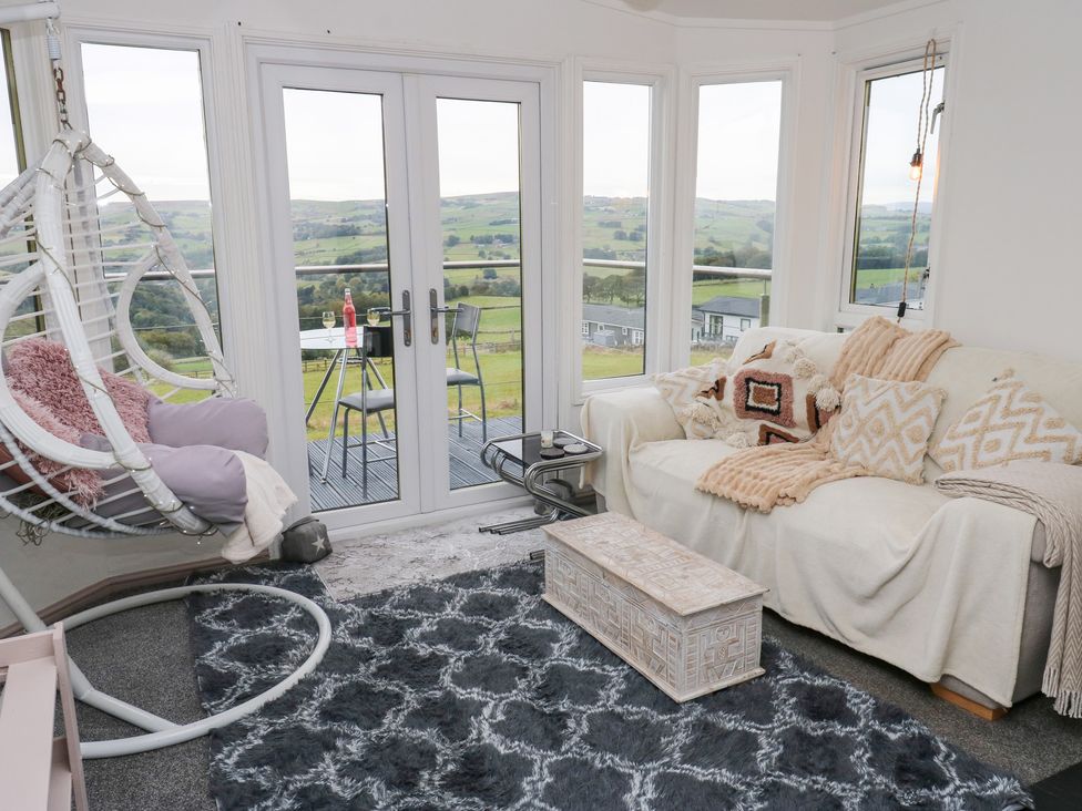 A snug with a swing chair and couch at John's Folly in 
