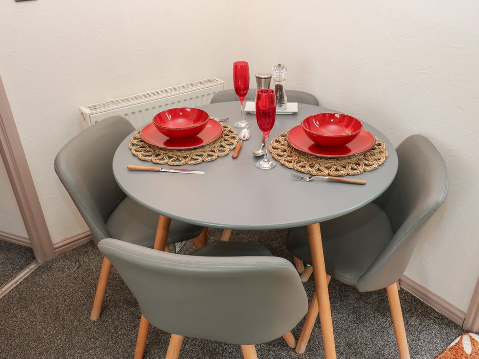 A dining table set with plates and drinks at John's Folly