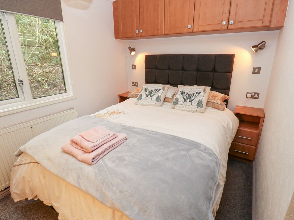 A bedroom with a double bed and bedside table at John's Folly