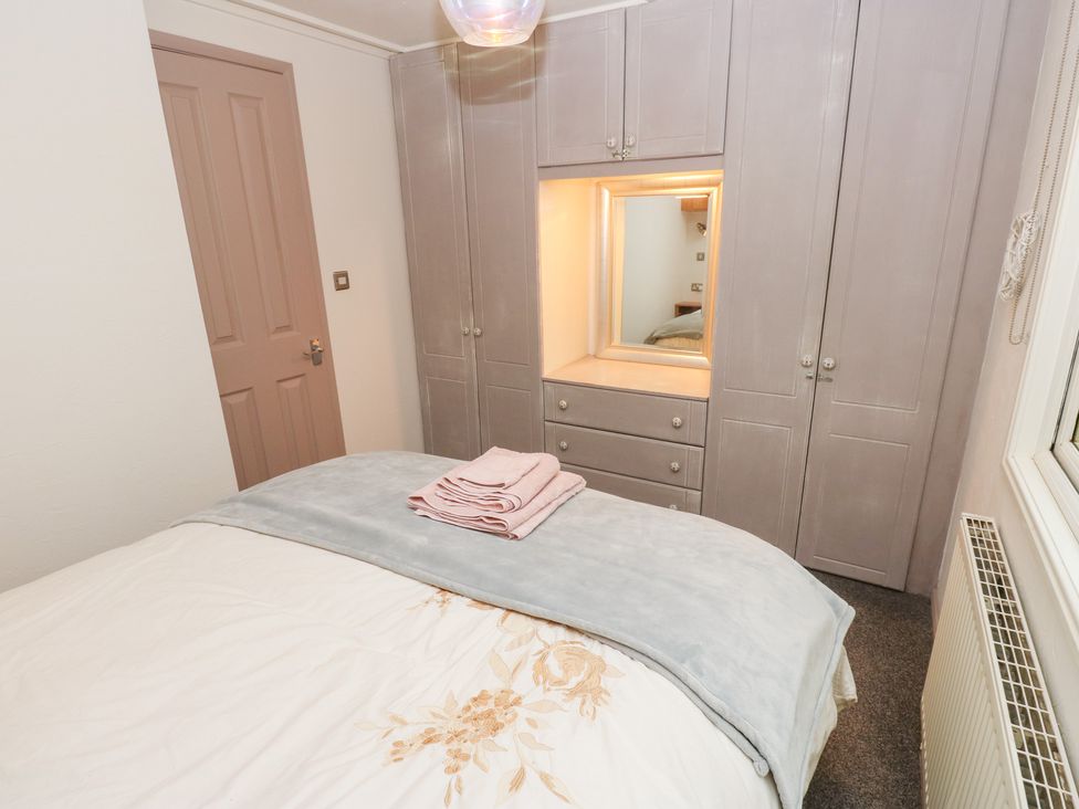 A bedroom with a bed and wardrobe at John's Folly