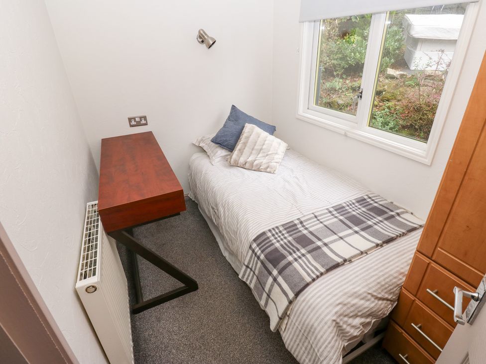 A bedroom with a bed and desk at John's Folly
