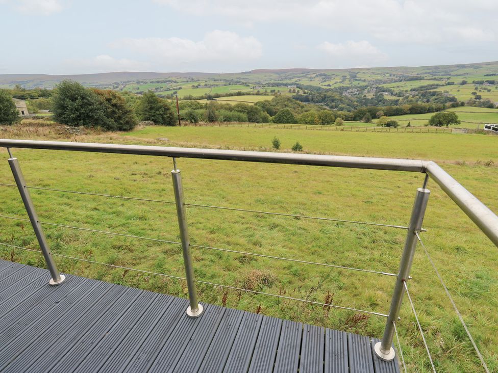 A balcony view overlooking fields and hills at John's Folly