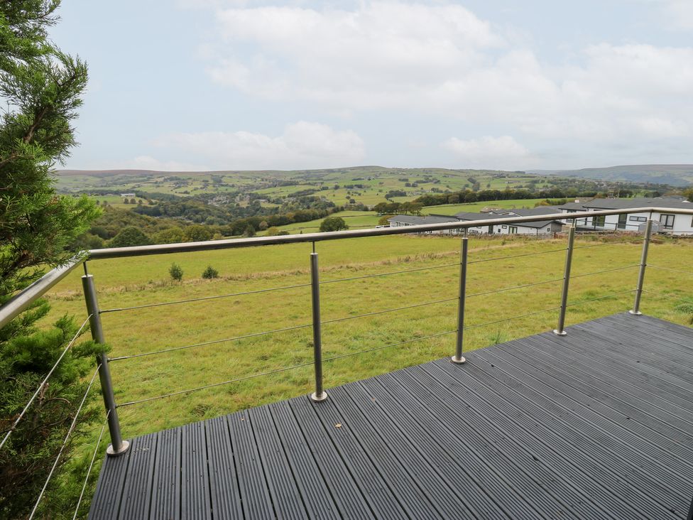 A deck with a view of hills and fields at John's Folly