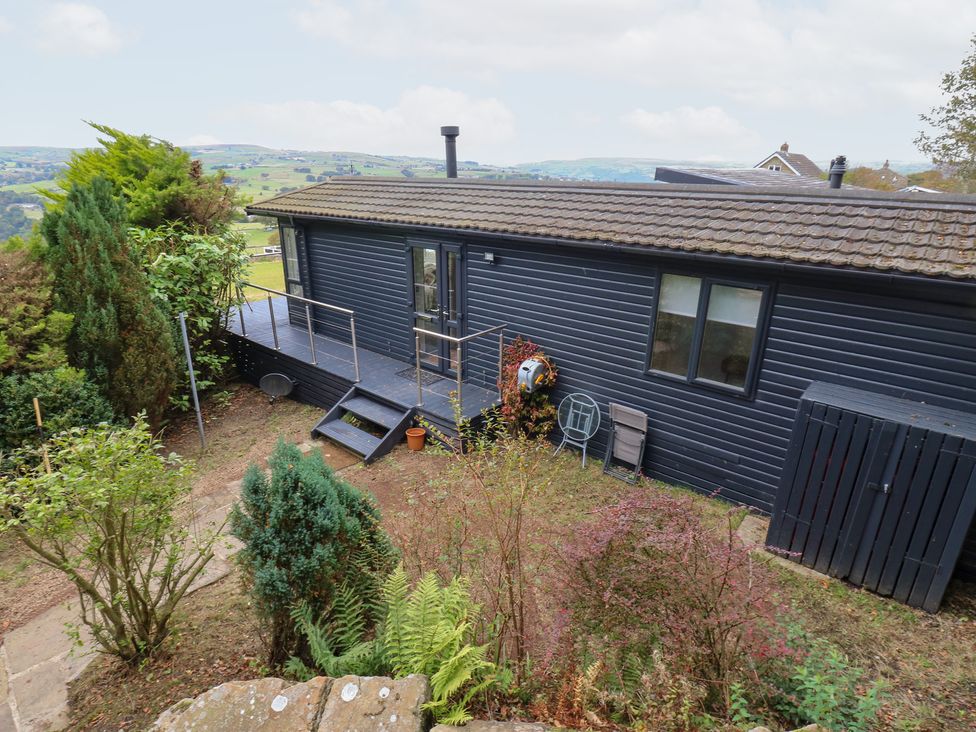 An outdoor area with a house and garden at John's Folly