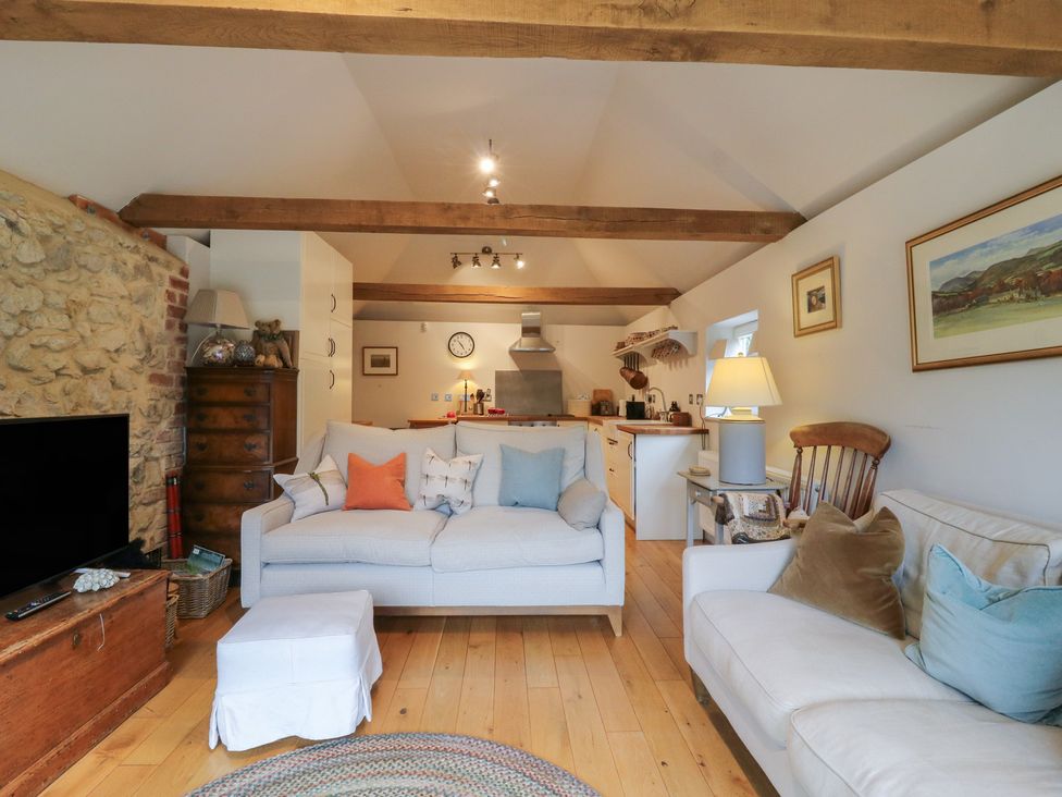 A living room with a sofa and a television at The Piggery in Maidstone