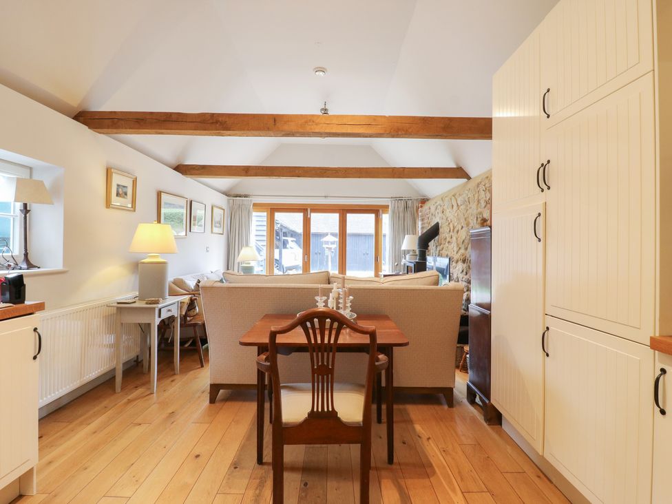 A living room with a table and sofa at The Piggery in Maidstone