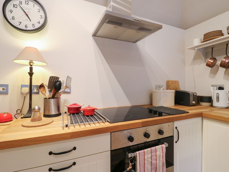 A kitchen with utensils, stove and appliances at The Piggery in Maidstone
