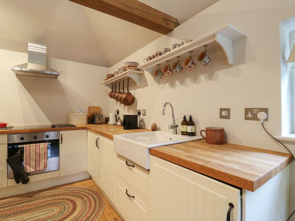A kitchen with a sink and stove at The Piggery in Maidstone