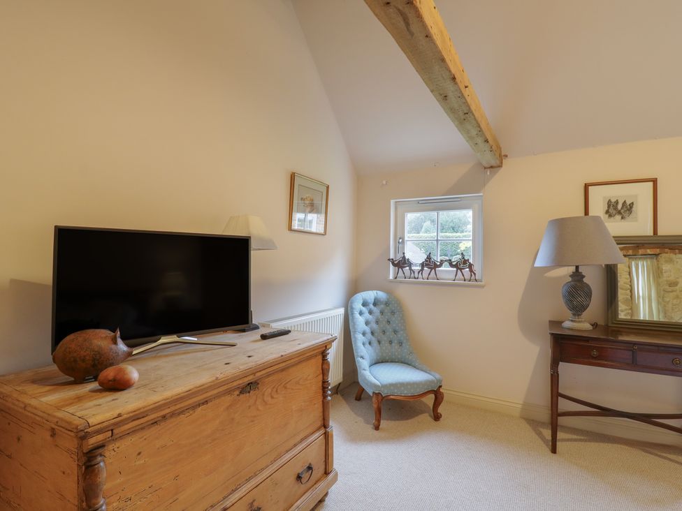 A bedroom with a television and chest of drawers at The Piggery in Maidstone