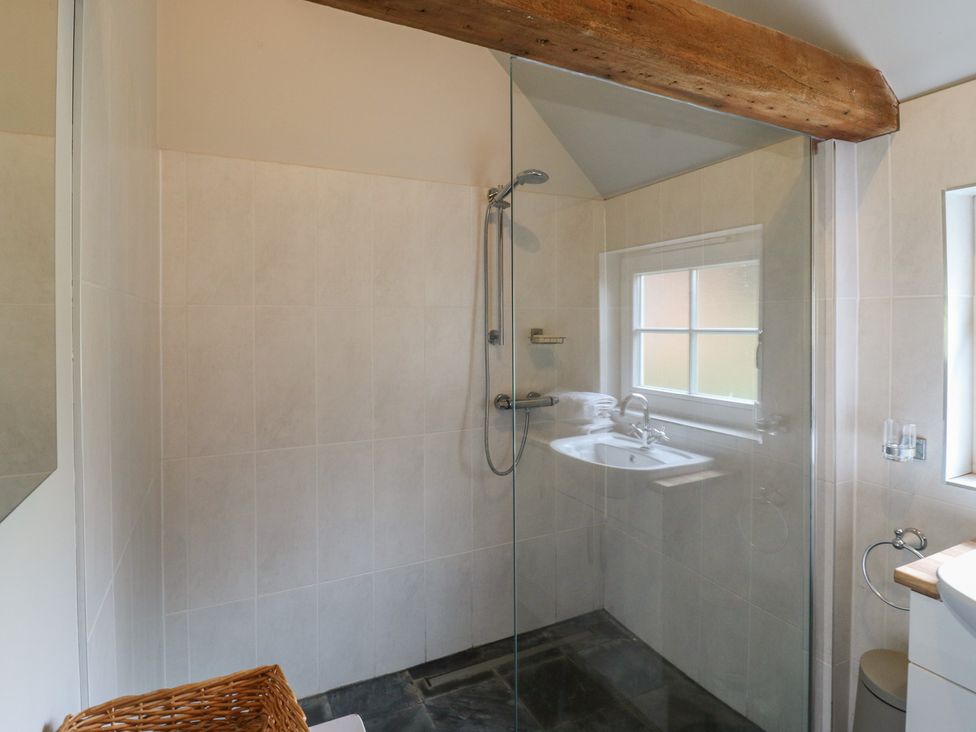 A bathroom with a shower and sink at The Piggery in Maidstone