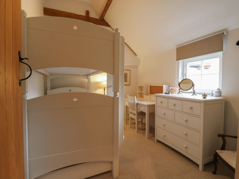 A bedroom with a bunk bed and a desk at The Piggery in Maidstone