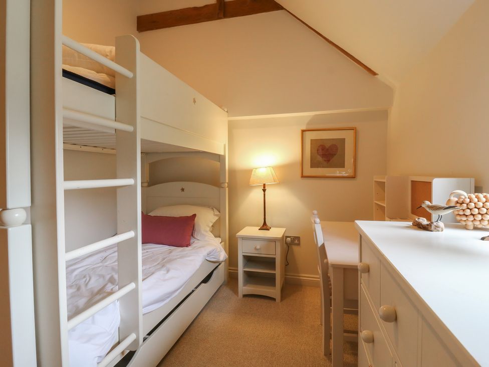 A bedroom with a bunk bed and desk at The Piggery in Maidstone