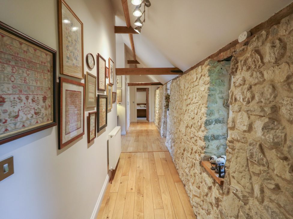 A hallway with artwork on the wall at The Piggery in Maidstone