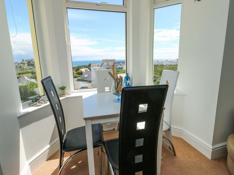 A dining area with a table and chairs at 19 Cliff Apartments in Trearddur Bay
