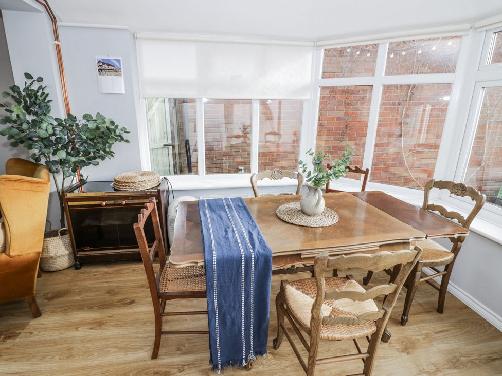A dining room with a table and chairs at 3 Leycester Court in Warwick