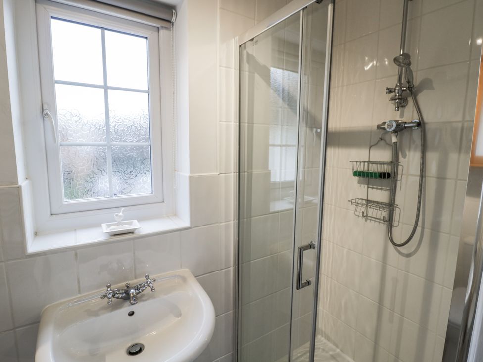 A bathroom with a sink and shower at 3 Leycester Court in Warwick