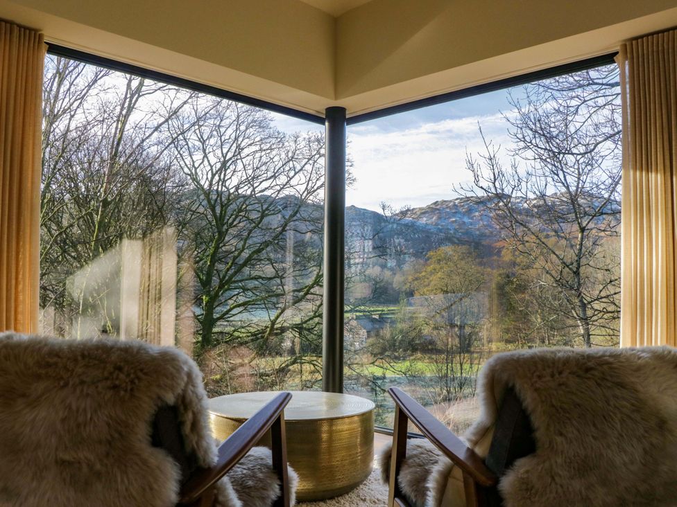 A sitting room with two chairs and a table at The Old Bunkhouse in Grasmere