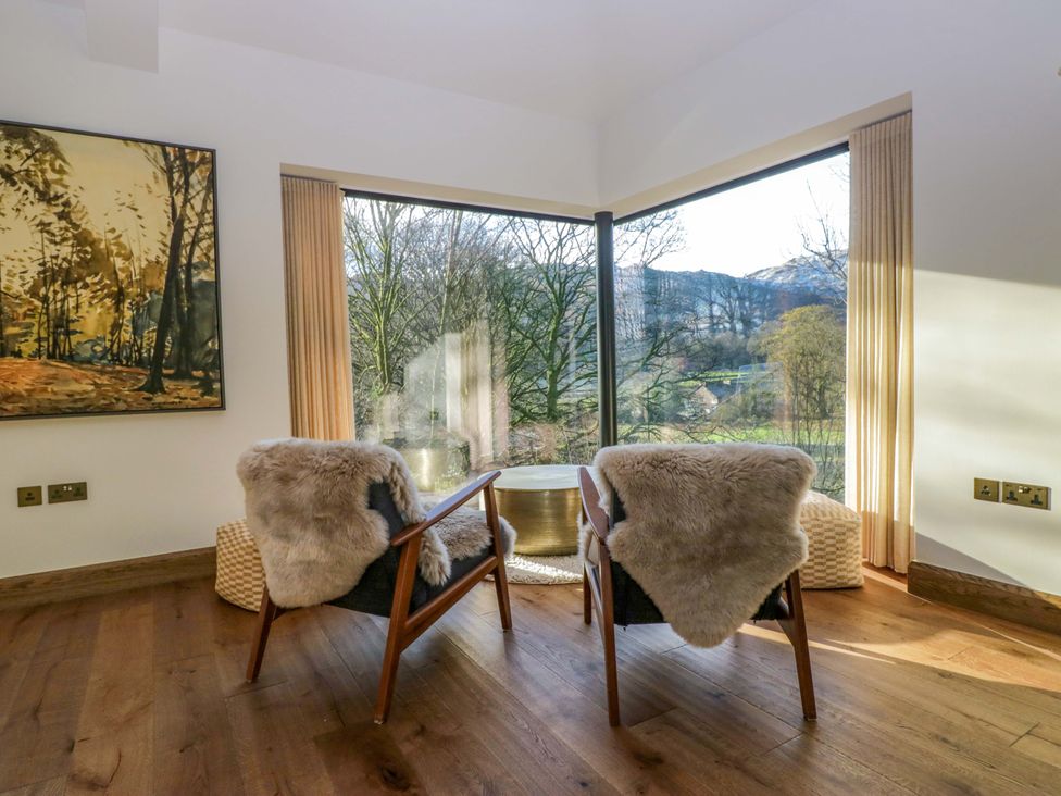 A living room with chairs and a table at The Old Bunkhouse in Grasmere