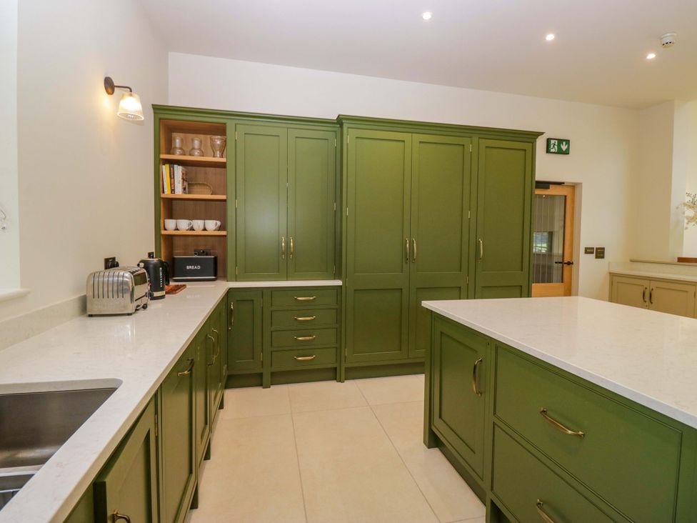 A kitchen with green cabinets and a countertop at The Old Bunkhouse in Grasmere