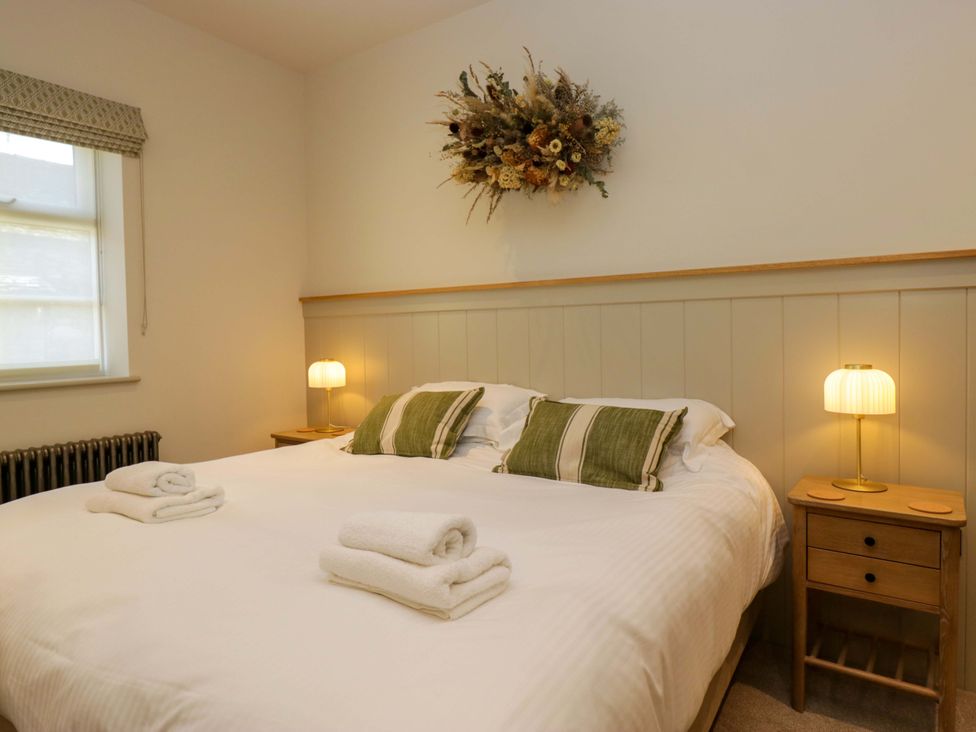 A bedroom with a bed and bedside table at The Old Bunkhouse in Grasmere