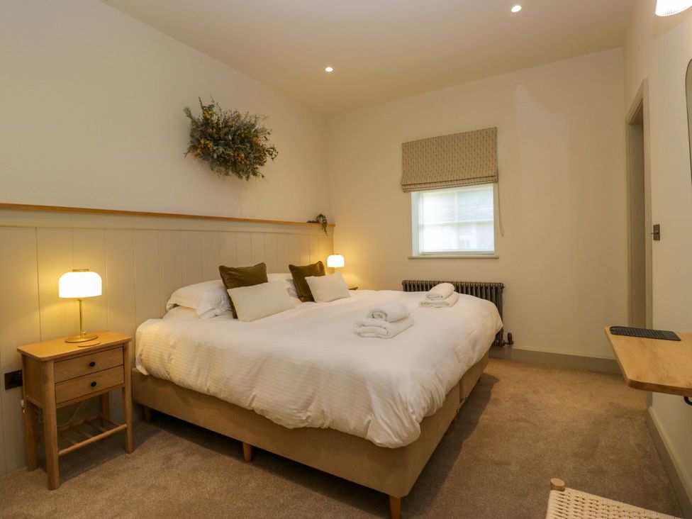 A bedroom with a bed and bedside table at The Old Bunkhouse in Grasmere