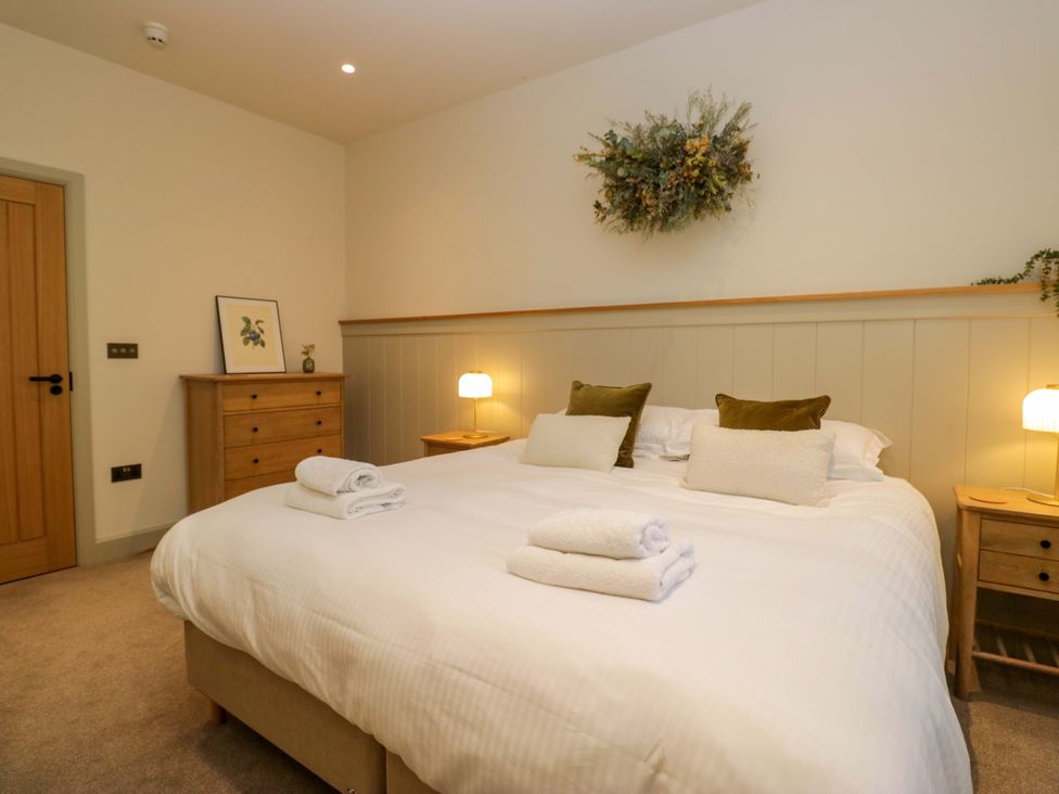 A bedroom with a bed and bedside tables at The Old Bunkhouse in Grasmere