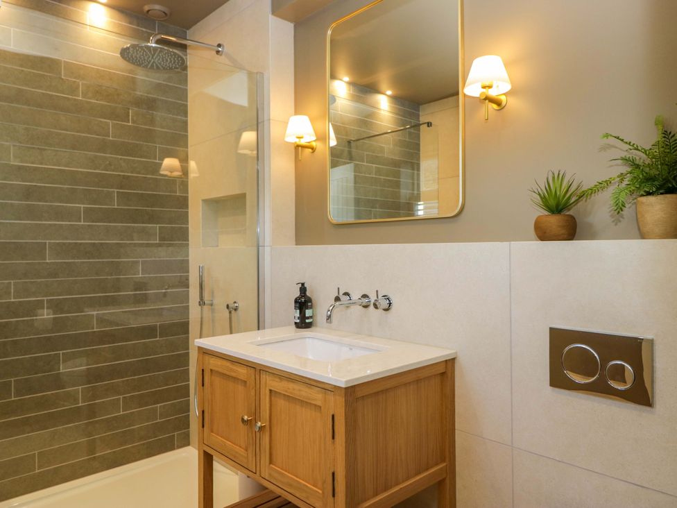 A bathroom with a shower and sink at The Old Bunkhouse in Grasmere