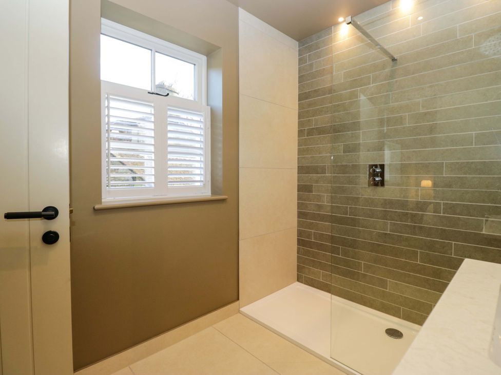 A bathroom with a shower and window at The Old Bunkhouse in Grasmere