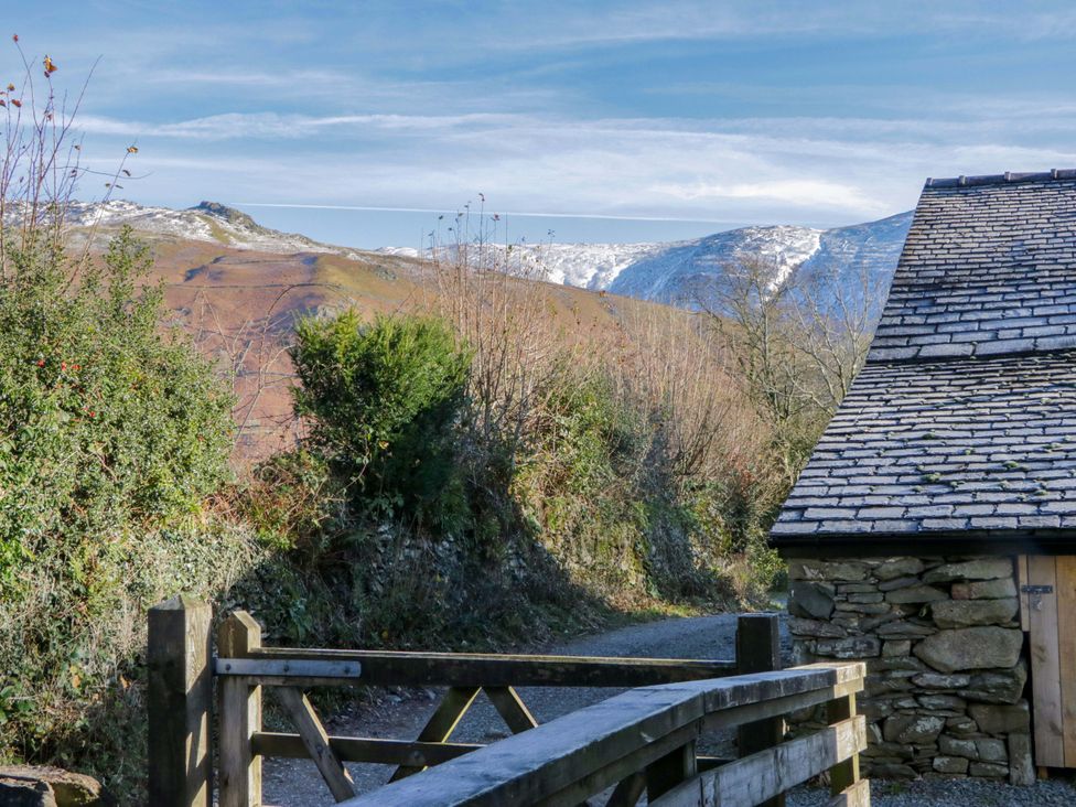 A path and gate with mountains in the background at The Old Bunkhouse in Grasmere