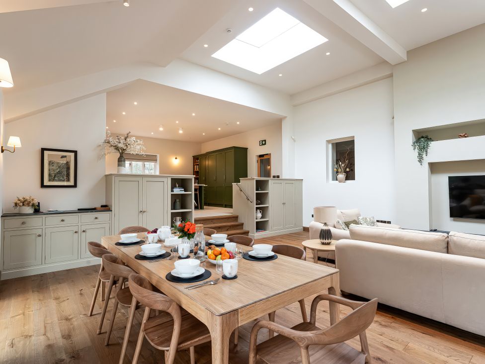 A living room with a dining table and sofa at The Old Bunkhouse in Grasmere
