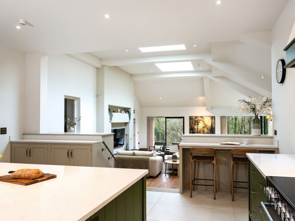 A kitchen with a counter and bar stools at The Old Bunkhouse in Grasmere