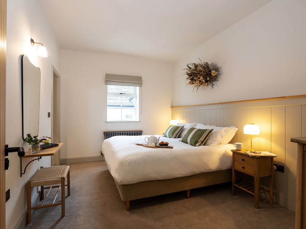 A bedroom with a bed and bedside table at The Old Bunkhouse in Grasmere