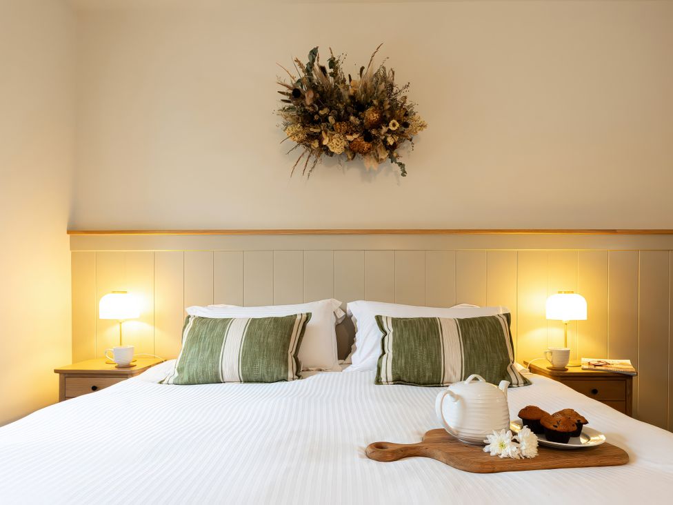 A bedroom with a bed and breakfast tray at The Old Bunkhouse in Grasmere