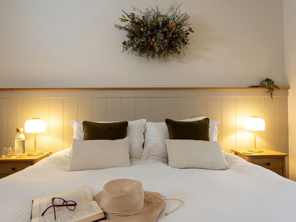 A bedroom with a bed and lamps on either side at The Old Bunkhouse in Grasmere