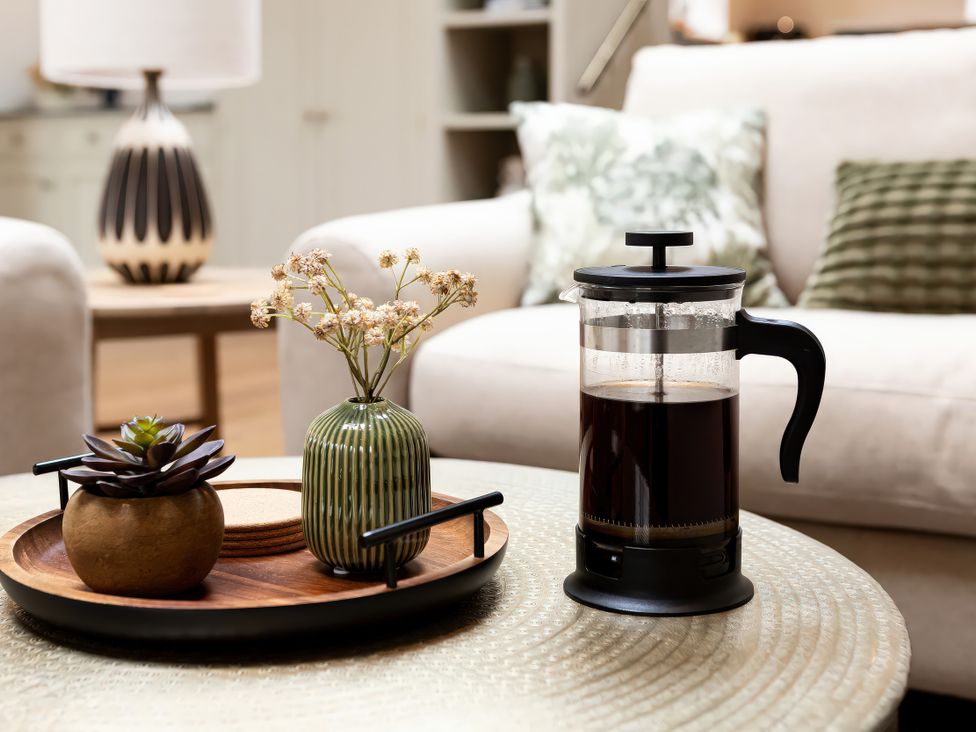 A living room with a coffee maker and decorative items at The Old Bunkhouse in Grasmere