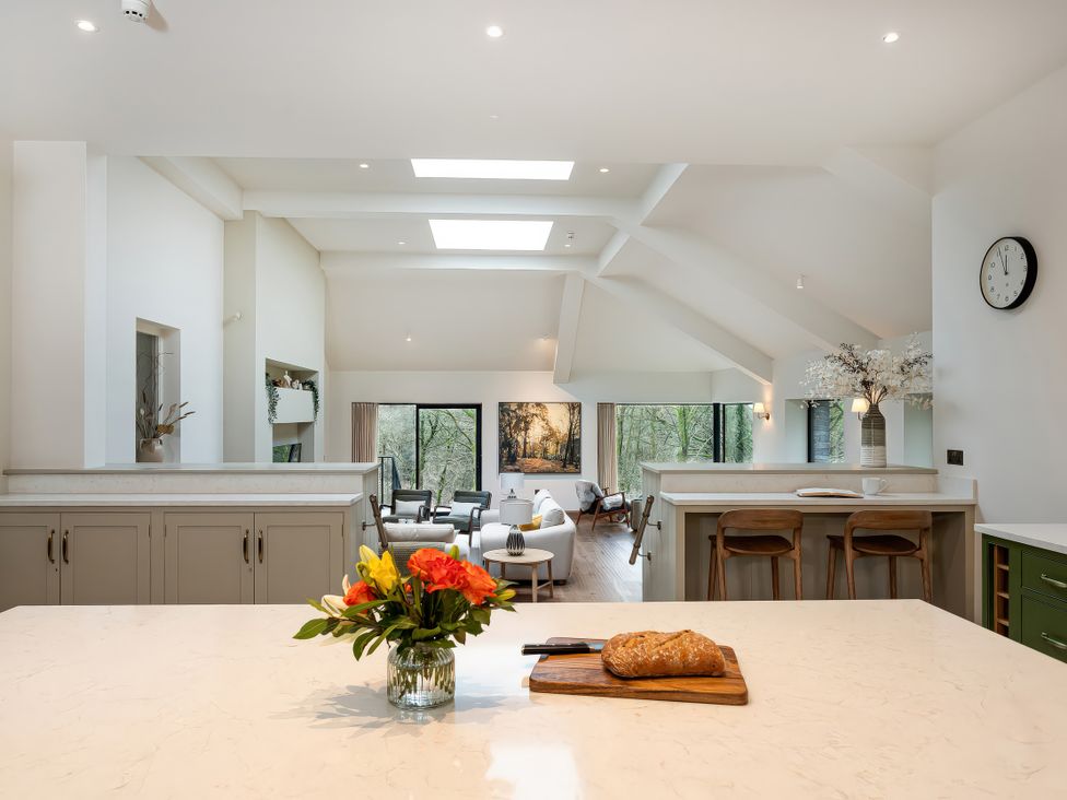 A kitchen with an island and bar stools at The Old Bunkhouse in Grasmere