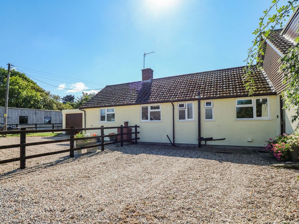 An outdoor view of a house with gravel area at Court House Farmhouse in Charmouth