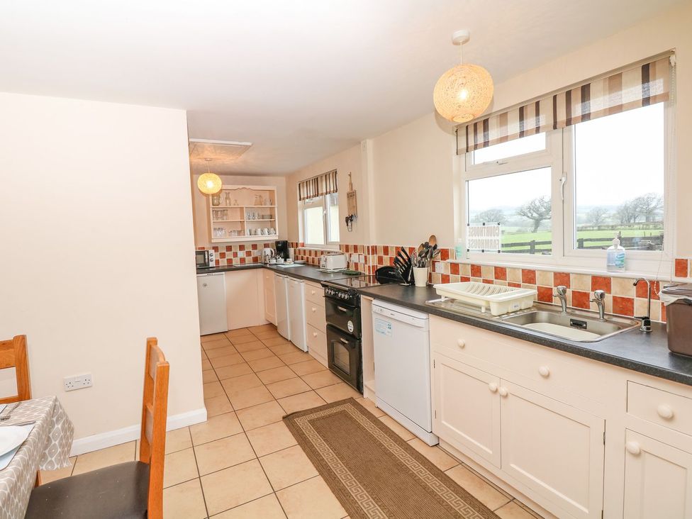 A kitchen with countertop and appliances at Court House Farmhouse in Charmouth