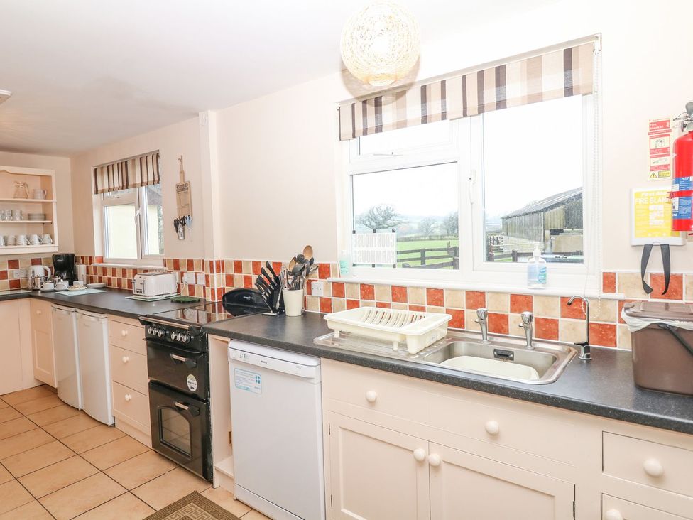 A kitchen with appliances and countertops at Court House Farmhouse in Charmouth