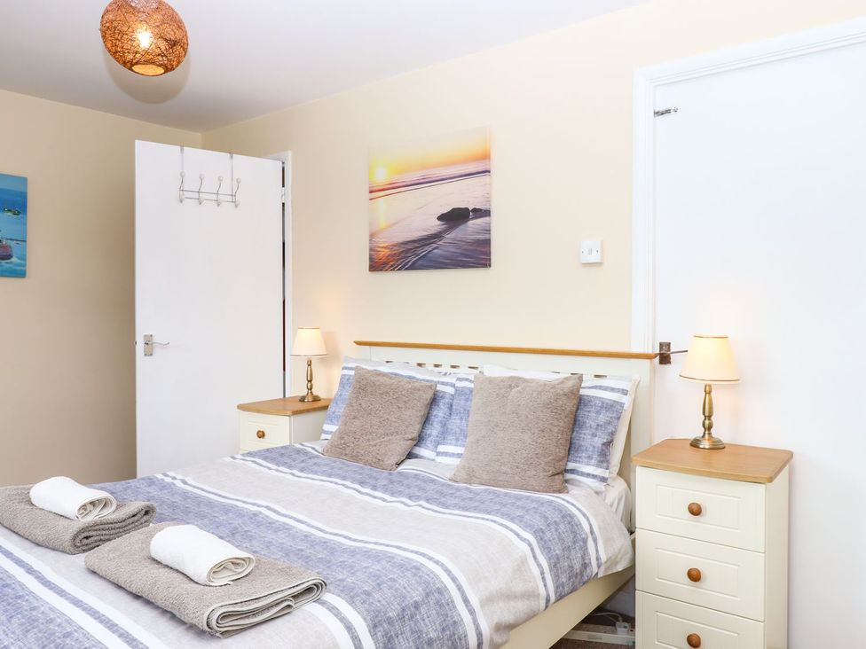 A bedroom with a bed and bedside tables at Court House Farmhouse in Charmouth