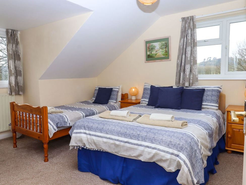 A bedroom with a double bed and a single bed at Court House Farmhouse, Charmouth
