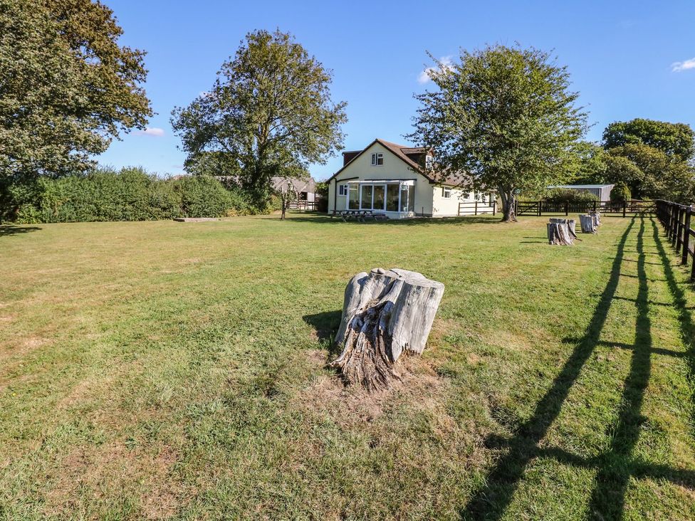 An outdoor view of a house and garden at Court House Farmhouse in Charmouth
