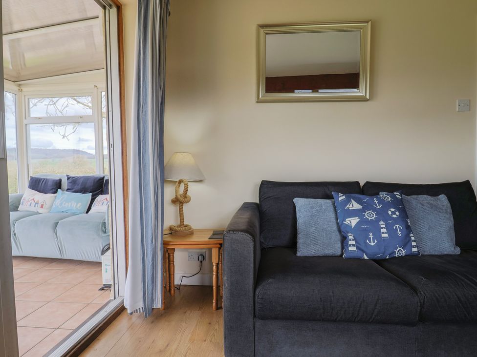 A snug area with a sofa and pillows at Court House Farmhouse in Charmouth