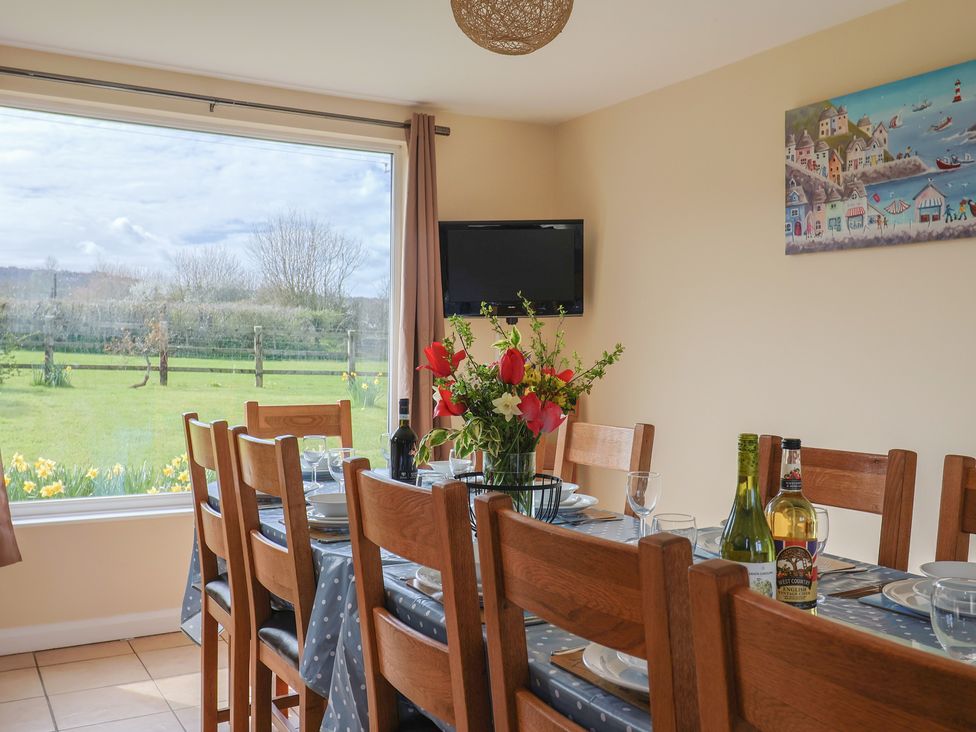 A dining room with a table set for dinner at Court House Farmhouse in Charmouth
