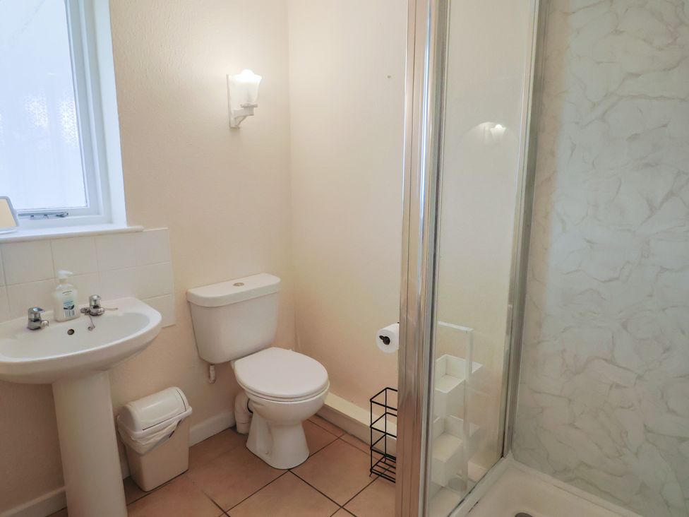 A bathroom with a sink and shower at Court House Farmhouse in Charmouth