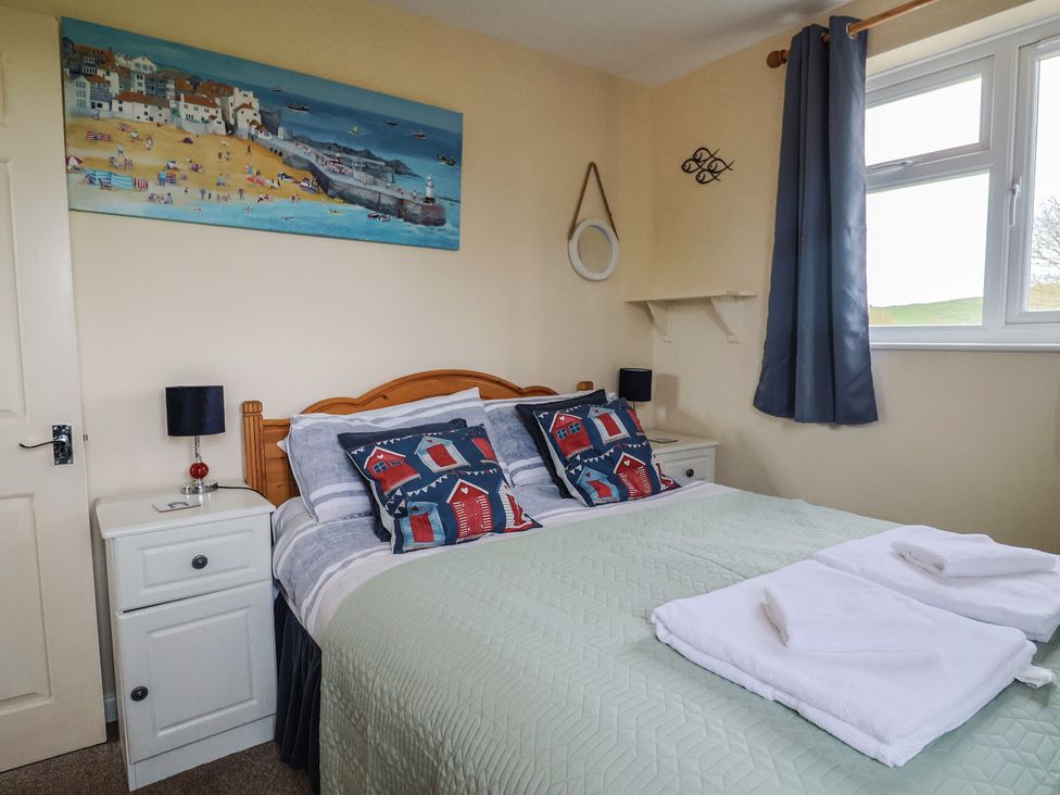 A bedroom with a bed and bedside table at Court House Farmhouse in Charmouth