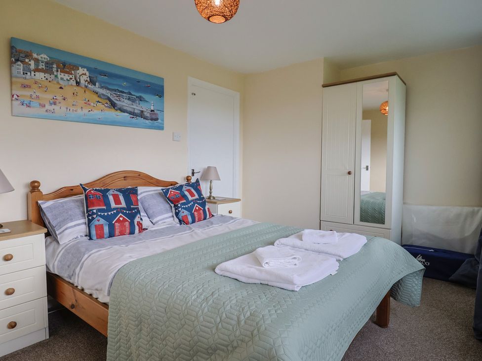A bedroom with a bed and wardrobe at Court House Farmhouse in Charmouth