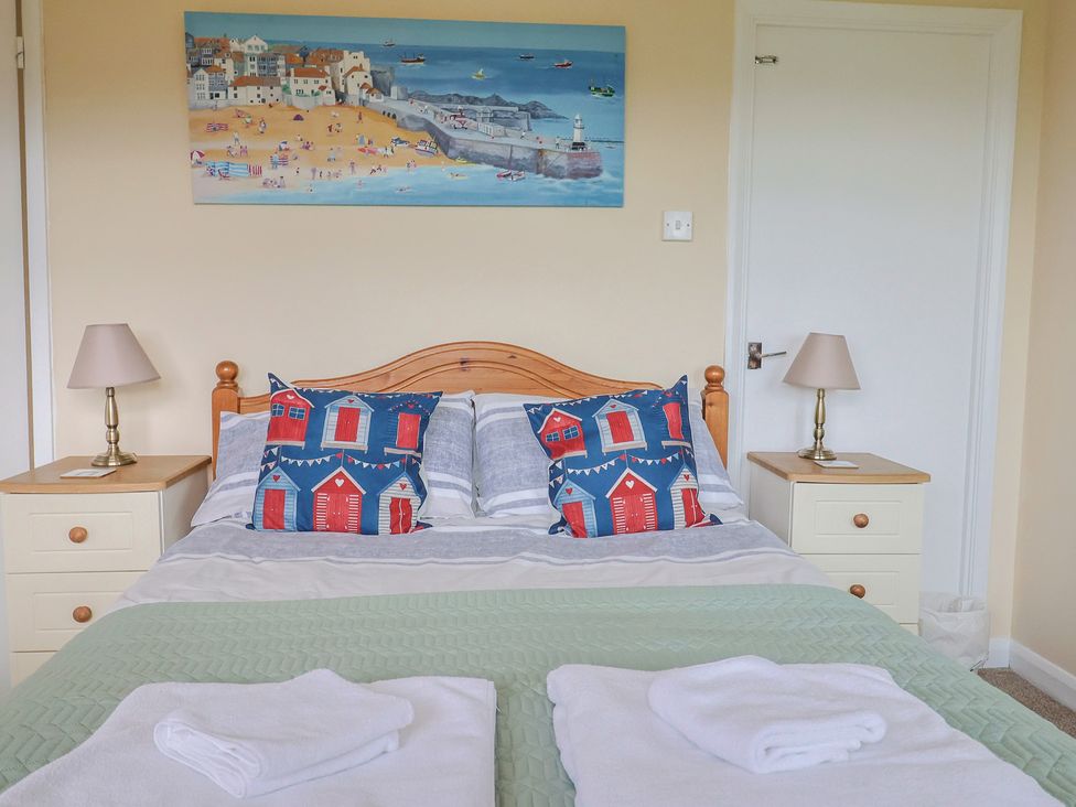 A bedroom with a bed and bedside table at Court House Farmhouse in Charmouth